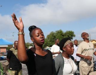 Worshipers hold Sunday service in parking lot